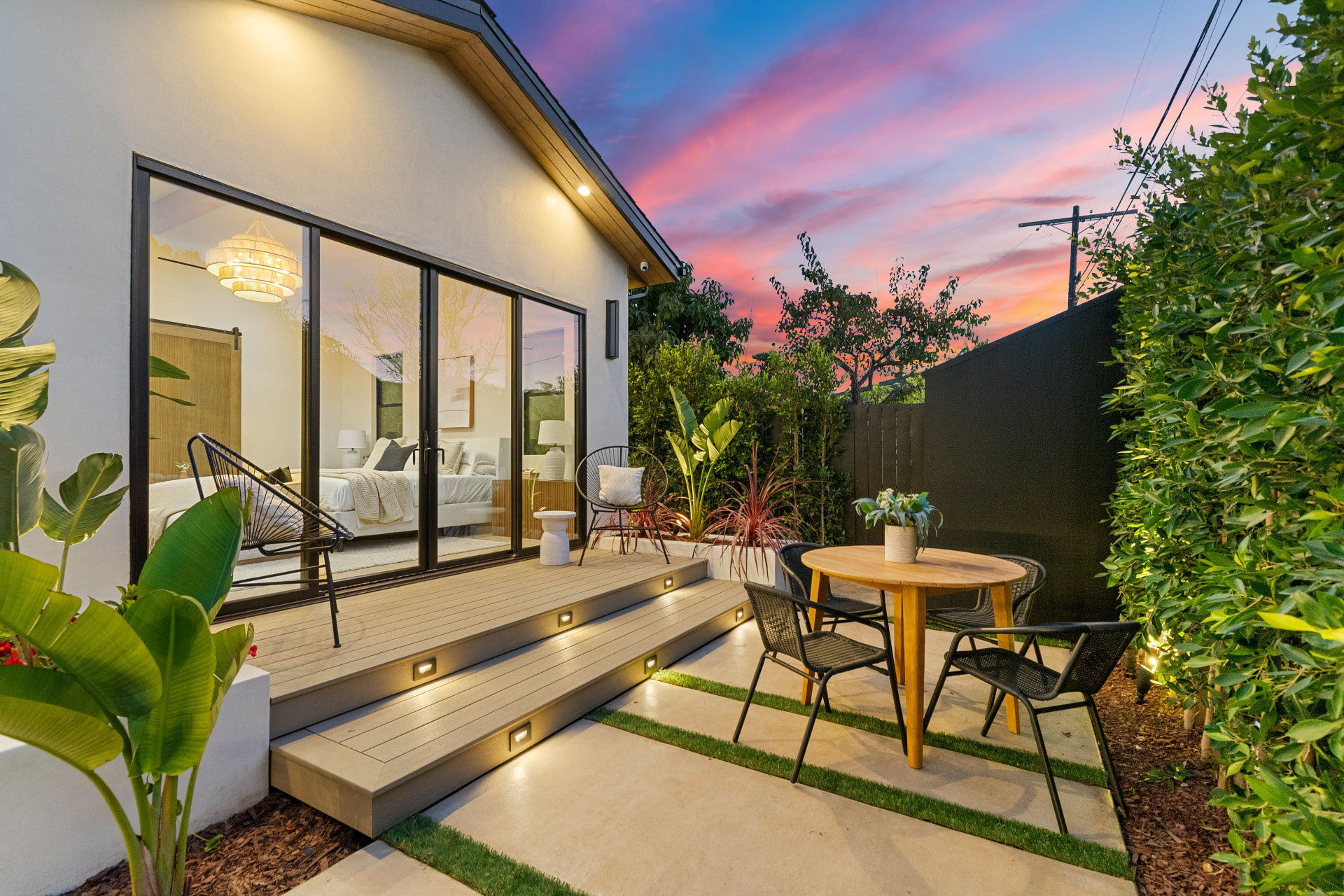 Folsom Hillside Composite Deck, Elevated multi-level composite deck on engineered footings with cable railing and integrated stair lighting.